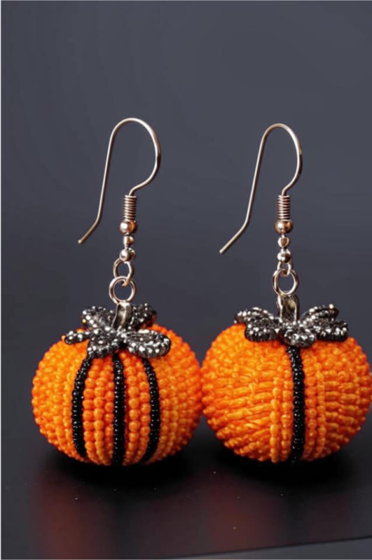 Pumpkin-shaped beaded earrings with black accents and metal hooks