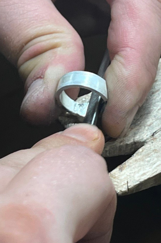 Handcrafting a silver ring, close-up of jewelry-making process